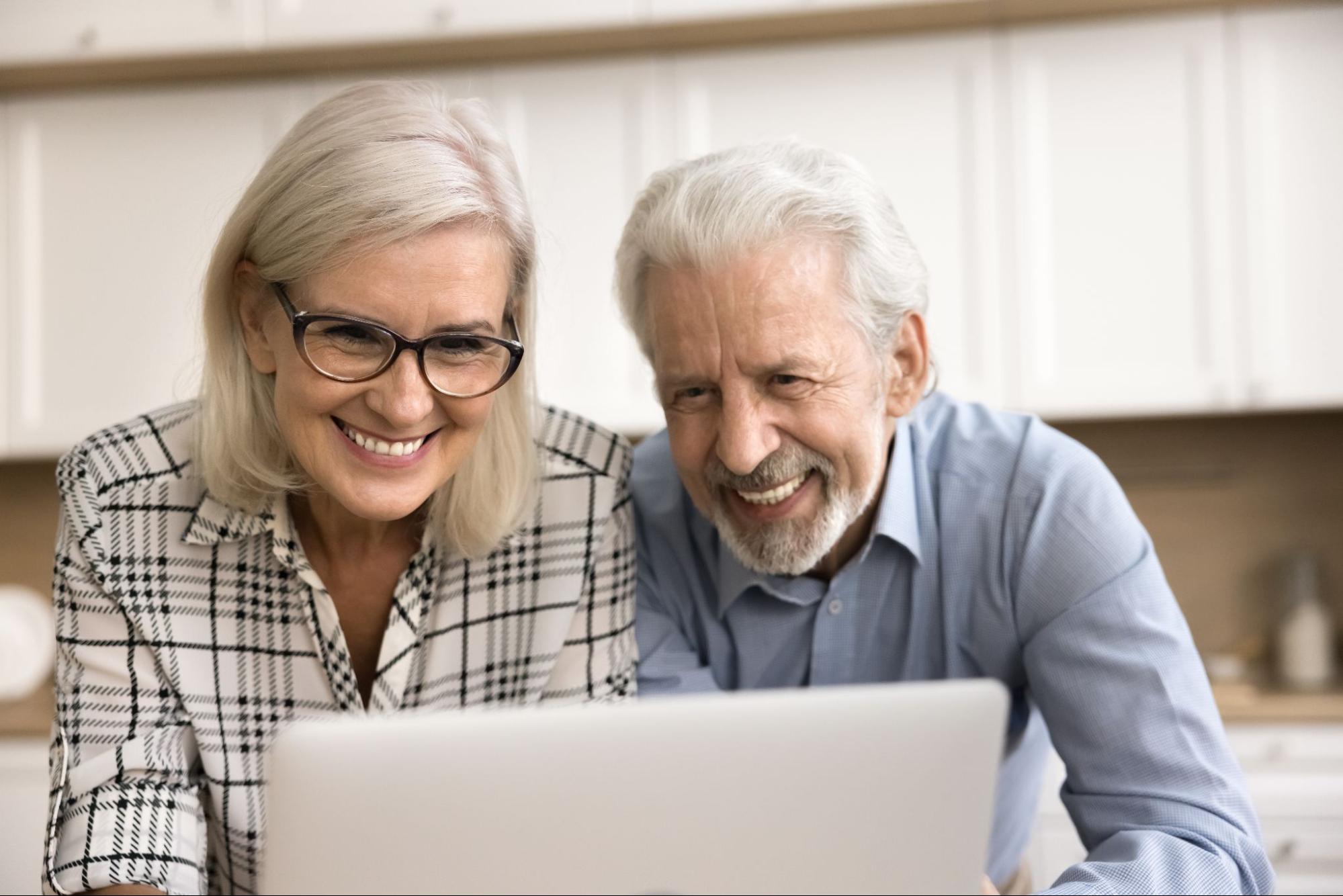 Older couple participating in a virtual estate planning consultation on a laptop